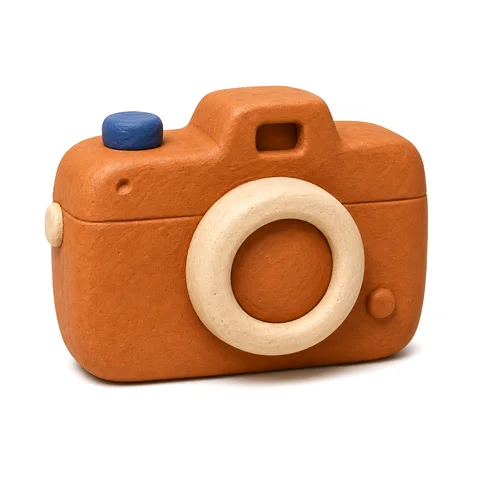 A hand-molded clay toy camera with a celadon lens.